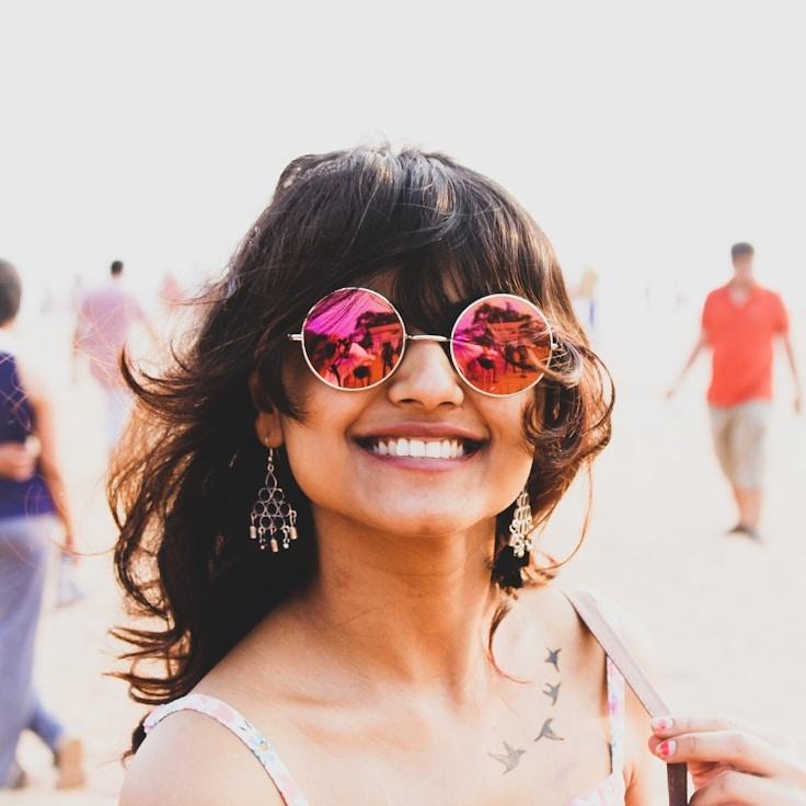 Kaveri Mehta, Lead Design Curator at DeltaCrestGroup, reviewing corporate floral arrangements